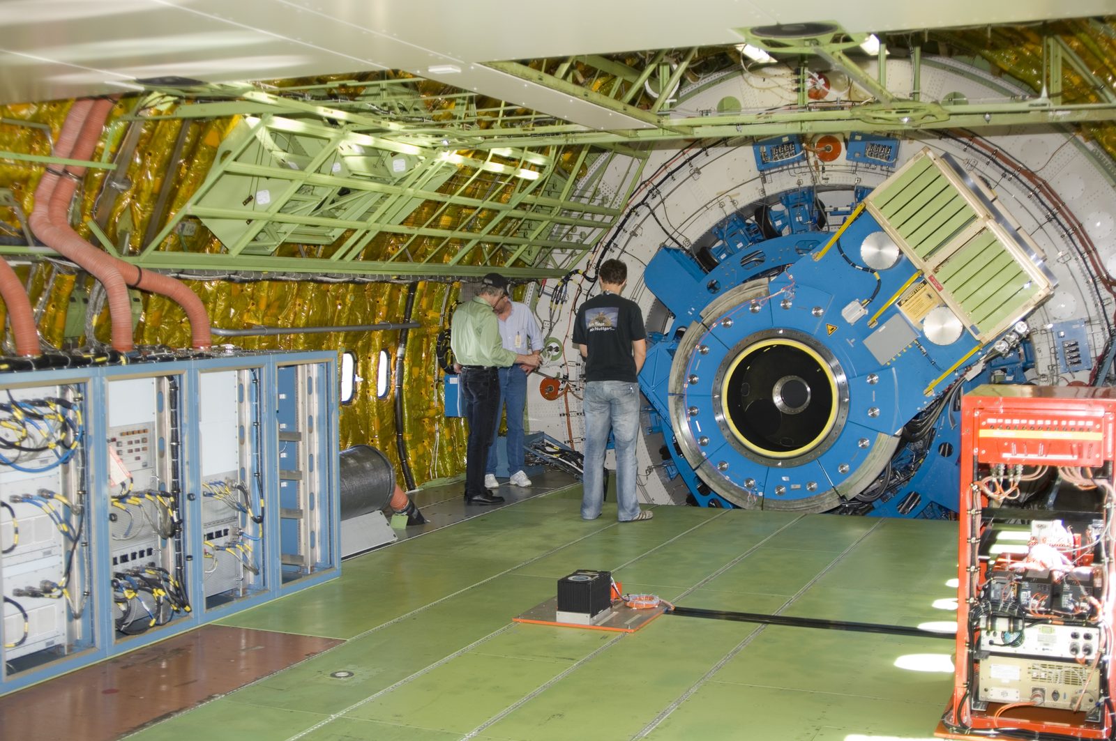Someone working in Astronomy — Ellis Abel Learns Technicians on a work platform check the mounting structure of the 20-ton infrared telescope installed inside NASA's SOFIA airborne observatory. Real NASA photograph used on the Ellis Abel Learns "Why I Love Astronomy" page.