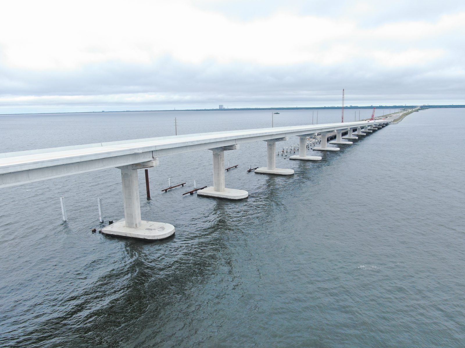 An aerial view of construction crews and barges working to complete the westbound span of the Indian River causeway bridge. Real NASA photograph used on the Ellis Abel Learns "Why I Love Bridges" page.