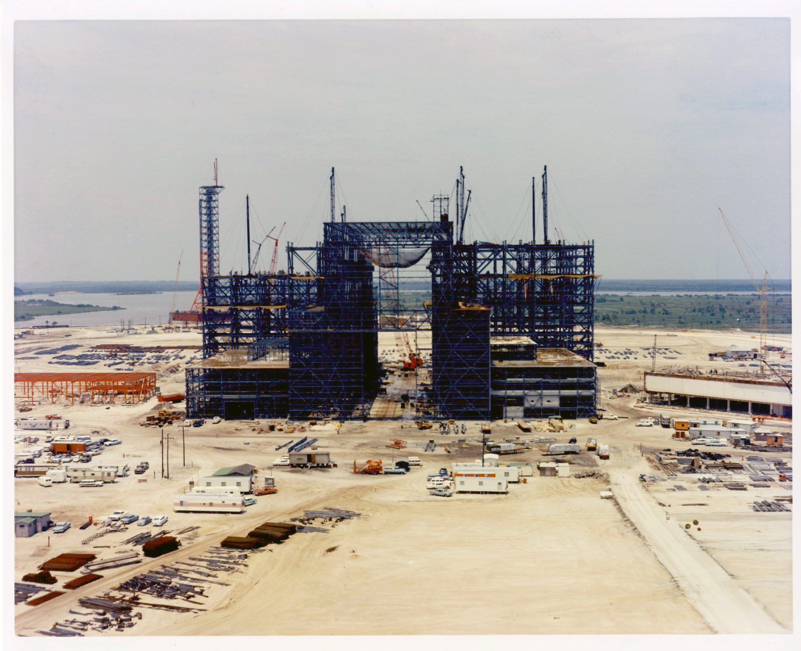 An aerial photograph of the Vehicle Assembly Building under construction at Kennedy Space Center, its steel frame still open to the sky. Real NASA photograph used on the Ellis Abel Learns "Why I Love Building" page.