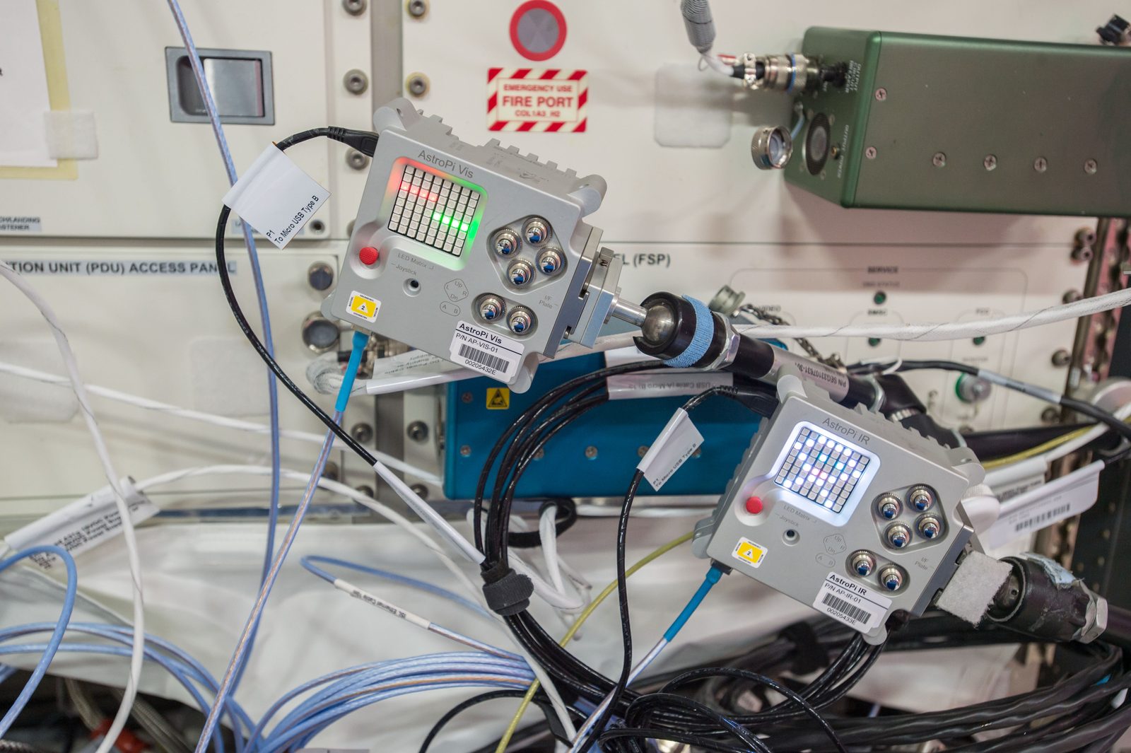 Two small AstroPi Raspberry Pi computers with camera modules floating in the Columbus laboratory of the space station. Real NASA photograph used on the Ellis Abel Learns "Why I Love Coding" page.