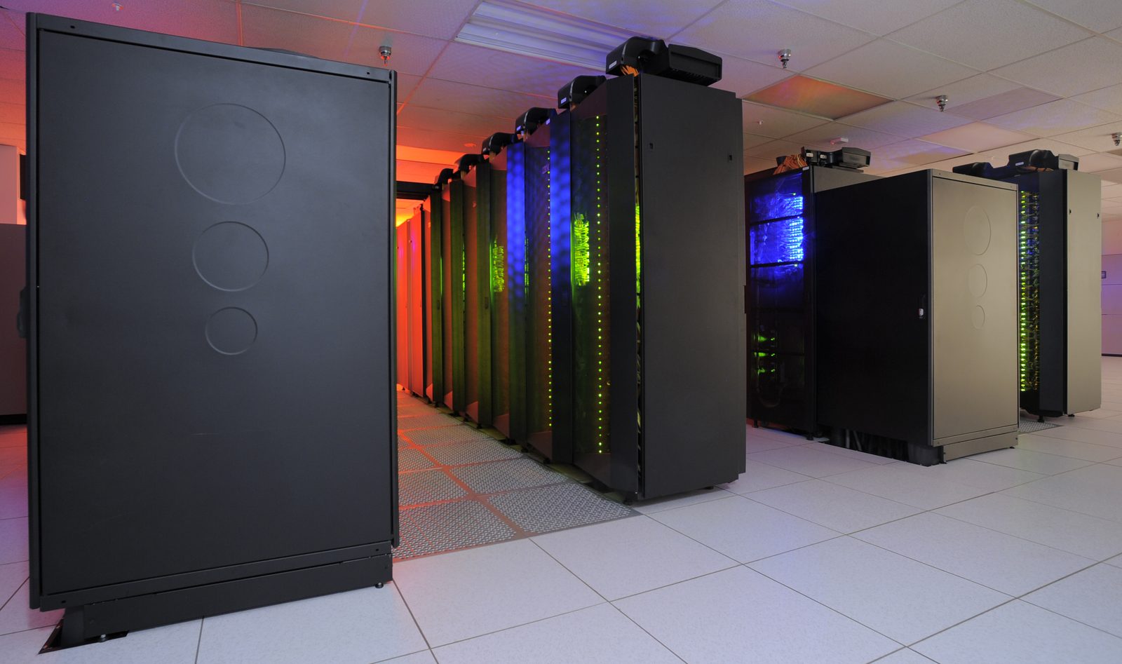 Long rows of black cabinets housing the Discover supercomputer at the NASA Center for Climate Simulation. Real NASA photograph used on the Ellis Abel Learns "Why I Love Computers" page.