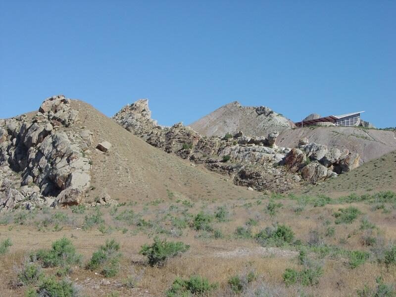 The historic quarry building at Dinosaur National Monument, built over steeply tilted Jurassic rock layers that hold a dinosaur bone bed. Real USGS photograph used on the Ellis Abel Learns "Why I Love Dinosaurs" page.