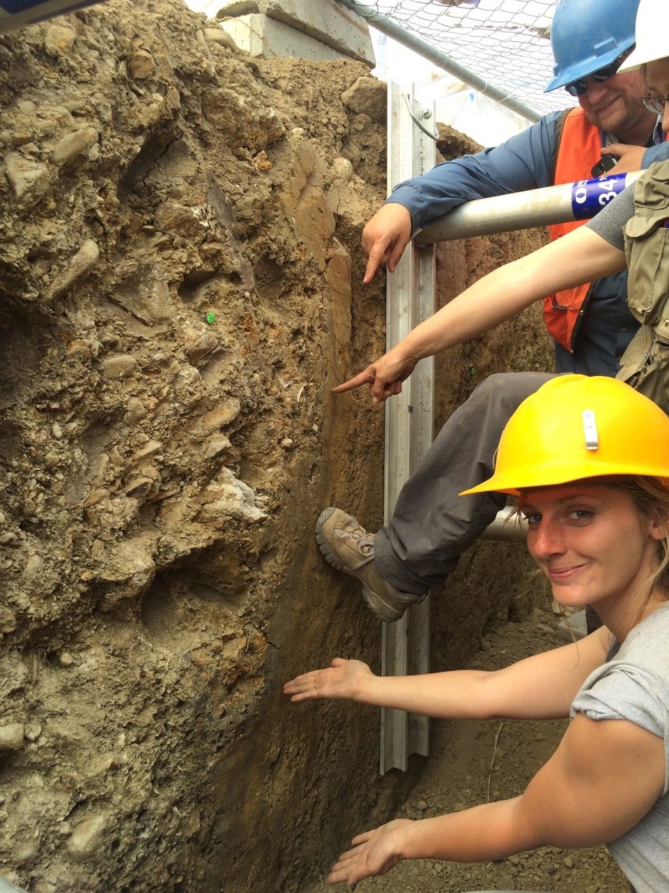 Someone working in Earthquakes — Ellis Abel Learns USGS scientists Alexandra Pickering, Suzanne Hecker and Aaron Page stand in an excavated trench pointing at the fault line exposed in its wall. Real USGS photograph used on the Ellis Abel Learns "Why I Love Earthquakes" page.