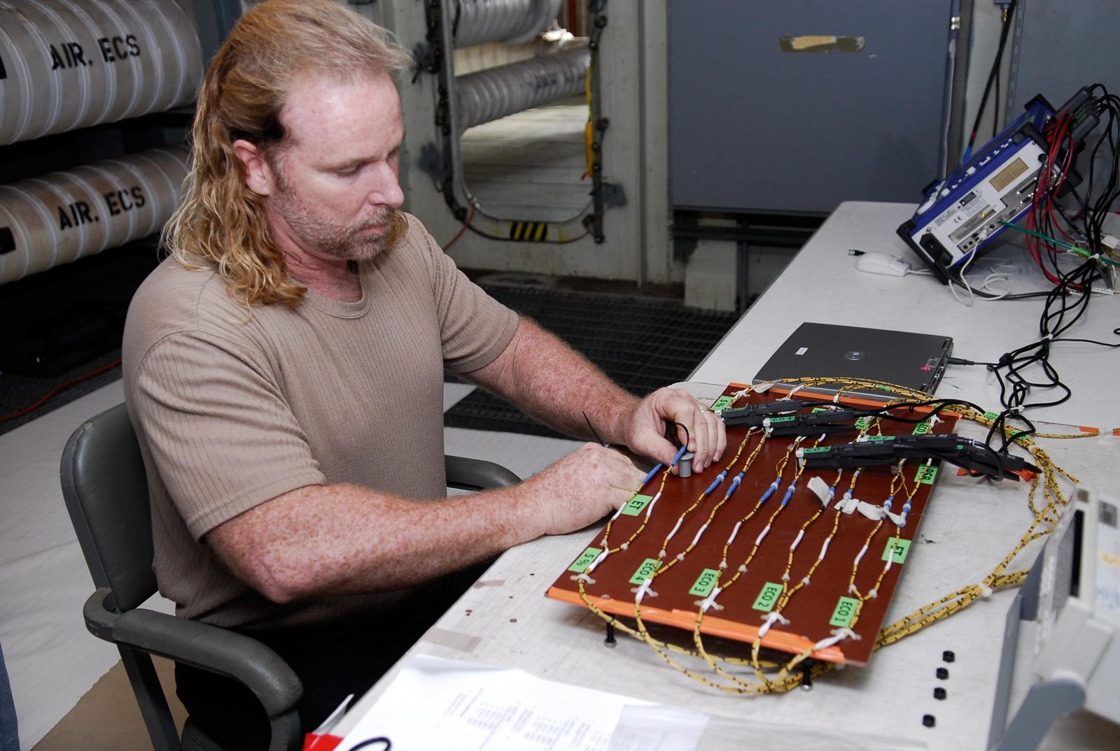 A technician sets up wiring and monitoring equipment at Launch Pad 39A for a shuttle tanking test. Real NASA photograph used on the Ellis Abel Learns "Why I Love Electricity" page.