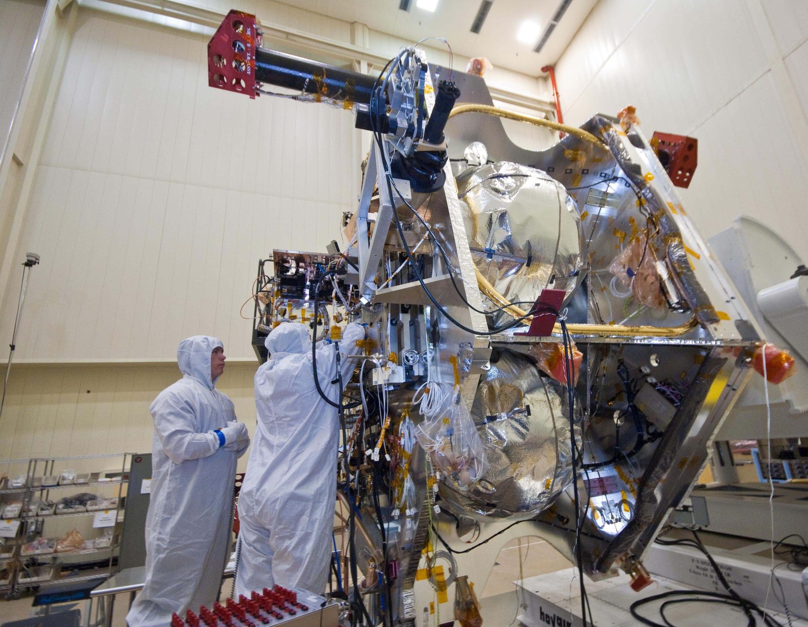 Technicians in clean-room gear install guidance, navigation and control electronics boxes into the Juno spacecraft. Real NASA photograph used on the Ellis Abel Learns "Why I Love Electronics" page.