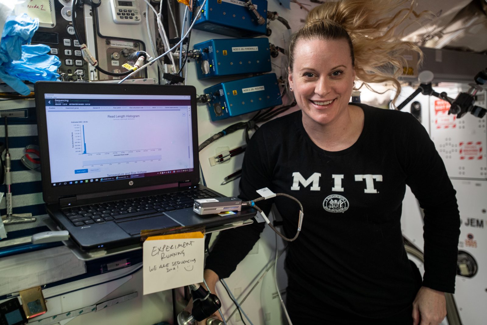 Astronaut Kate Rubins holds a handheld DNA sequencer while running a gene sequencing experiment aboard the space station. Real NASA photograph used on the Ellis Abel Learns "Why I Love Genetics" page.