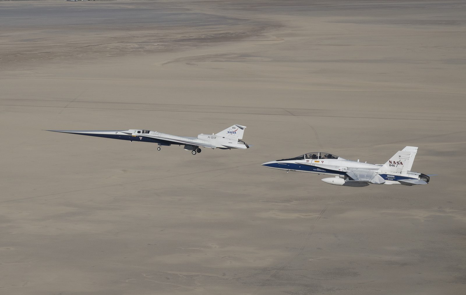 NASA's long-nosed X-59 quiet supersonic aircraft flies over the California desert alongside an F/A-18 chase plane. Real NASA photograph used on the Ellis Abel Learns "Why I Love Planes" page.