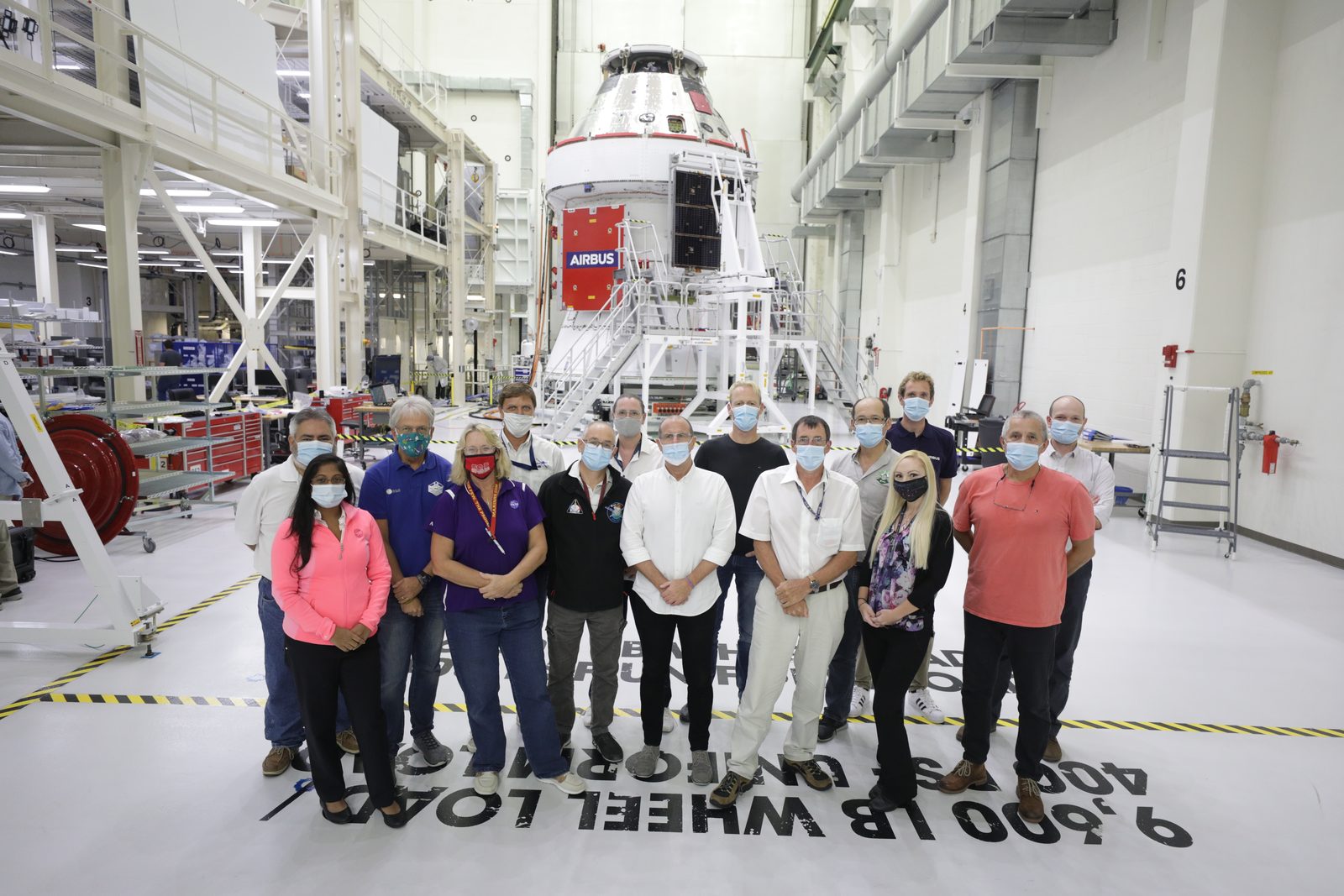 Someone working in Rockets — Ellis Abel Learns Members of the European Service Module processing team work around the Orion spacecraft during solar array wing installation. Real NASA photograph used on the Ellis Abel Learns "Why I Love Rockets" page.