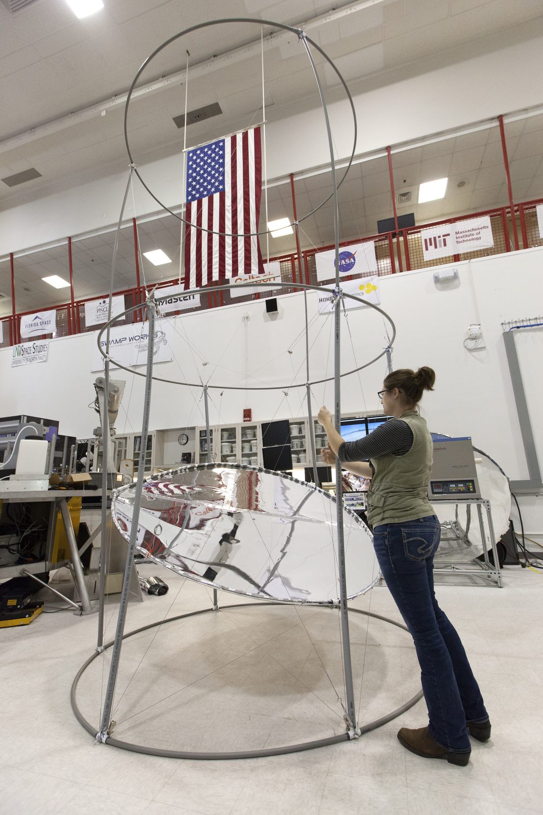 Someone working in Science — Ellis Abel Learns Student intern Maddy Olson works alongside NASA scientists at a bench in the Swamp Works laboratory at Kennedy Space Center. Real NASA photograph used on the Ellis Abel Learns "Why I Love Science" page.