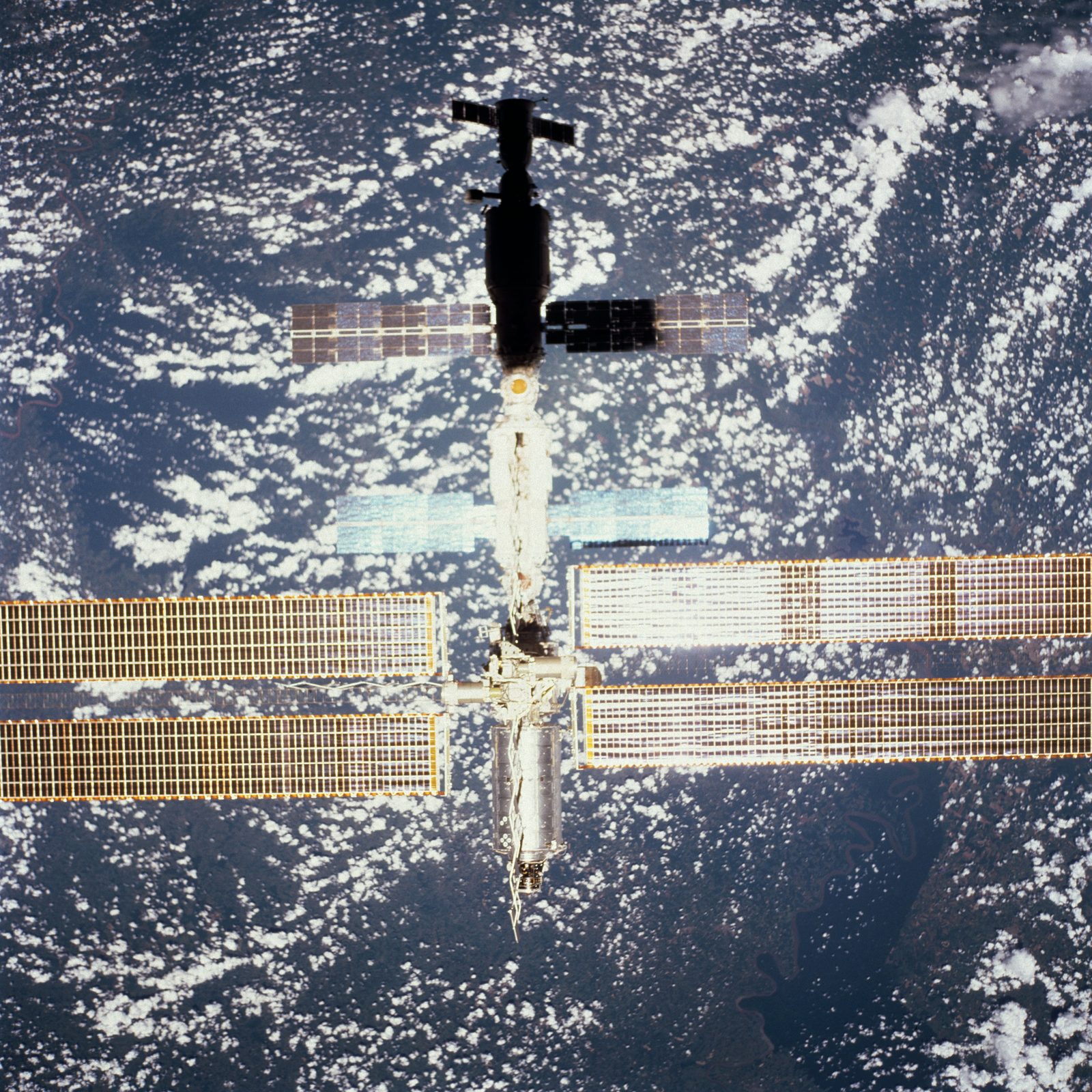 The International Space Station with its newly attached Destiny laboratory, photographed from space shuttle Atlantis above a cloud-covered Earth. Real NASA photograph used on the Ellis Abel Learns "Why I Love Space" page.