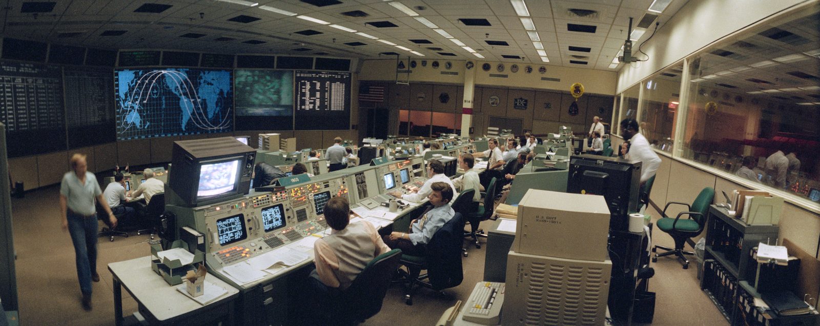 A wide-angle view of the flight control room of NASA's Mission Control Center, filled with rows of consoles and display screens. Real NASA photograph used on the Ellis Abel Learns "Why I Love Technology" page.