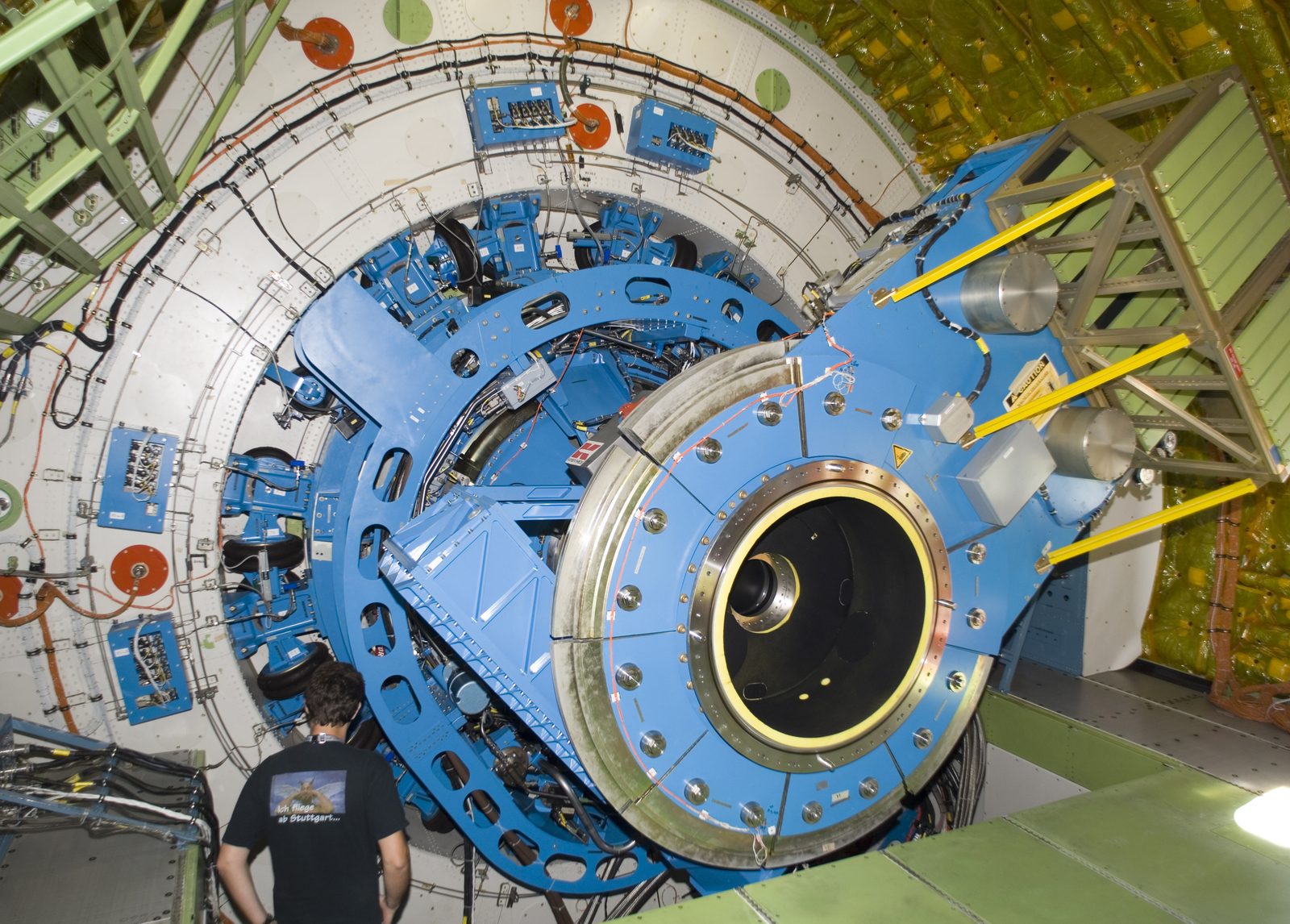 Someone working in Telescopes — Ellis Abel Learns A technician examines the instrument mounting structure and bulkhead of the German-built infrared telescope inside NASA's SOFIA aircraft. Real NASA photograph used on the Ellis Abel Learns "Why I Love Telescopes" page.