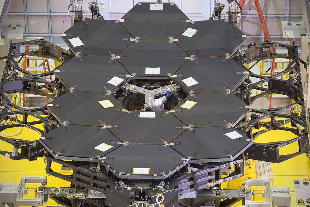 Twelve gold-coated hexagonal mirror segments of the James Webb Space Telescope installed side by side on the telescope's backplane at Goddard. Real NASA photograph used on the Ellis Abel Learns "Why I Love Telescopes" page.