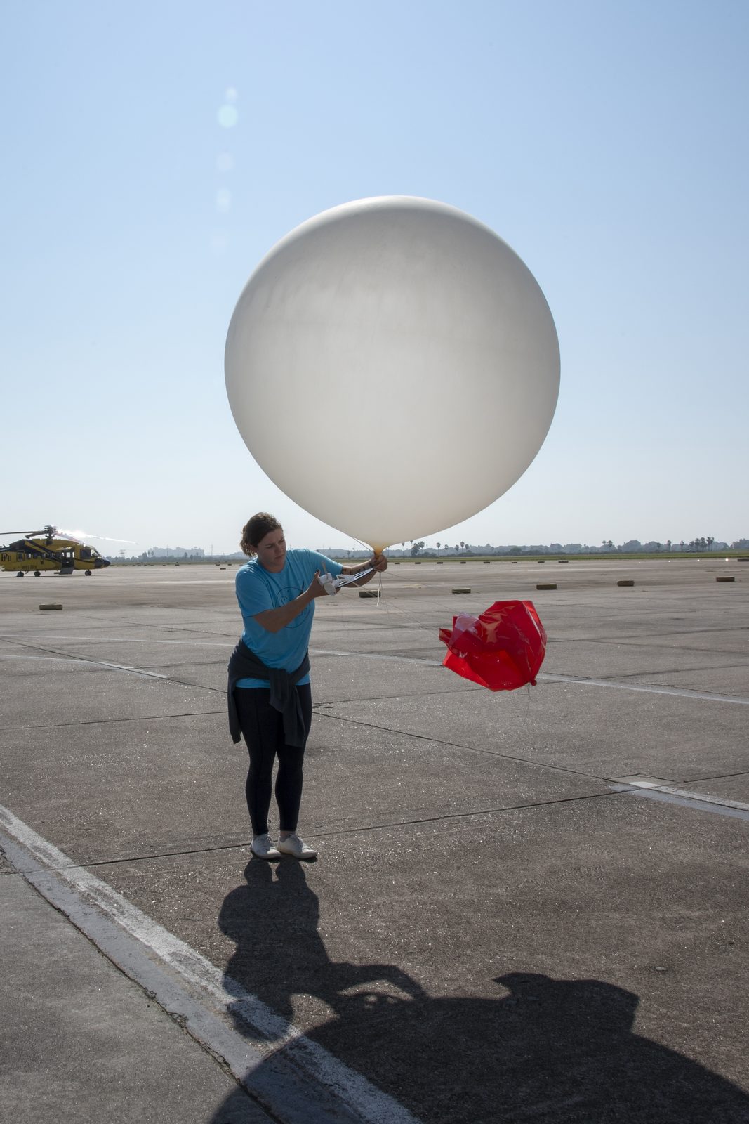 Someone working in Weather — Ellis Abel Learns NASA meteorologists release a white weather balloon into the sky to check conditions before a research flight. Real NASA photograph used on the Ellis Abel Learns "Why I Love Weather" page.