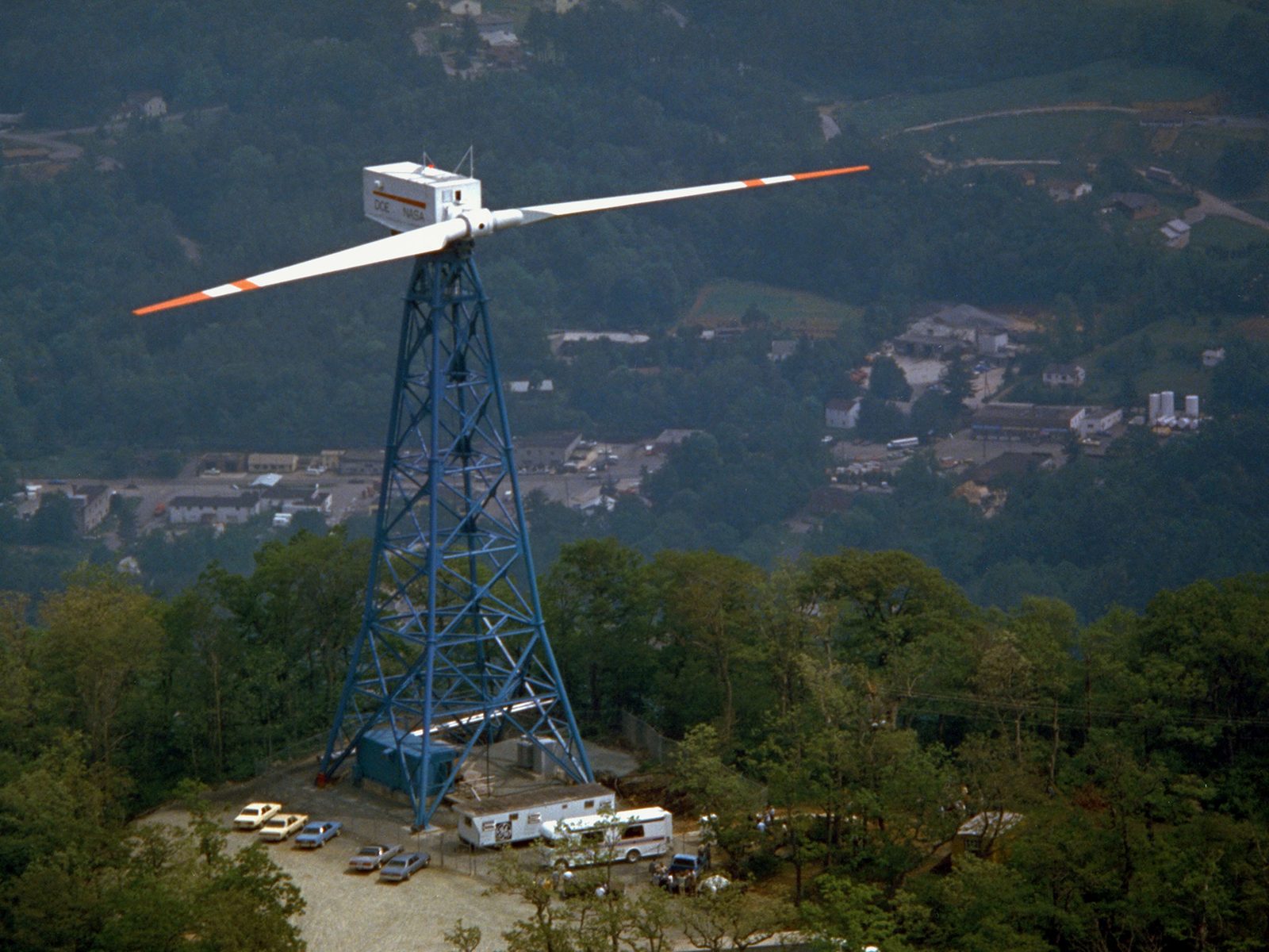 The two-bladed Mod-1 wind turbine standing on its lattice tower on a hilltop at Boone, North Carolina. Real NASA photograph used on the Ellis Abel Learns "Why I Love Wind Power" page.